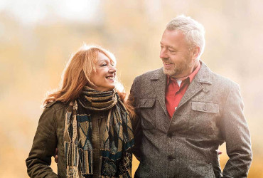 A couple walking together on a fall day